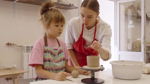 A Pottery Lesson with a Child in a Bright Creative Studio Setting