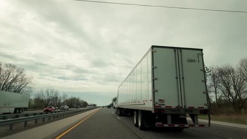 POV View of Delivery Truck Driving on a Scenic Highway Logistics and Transportation Concept