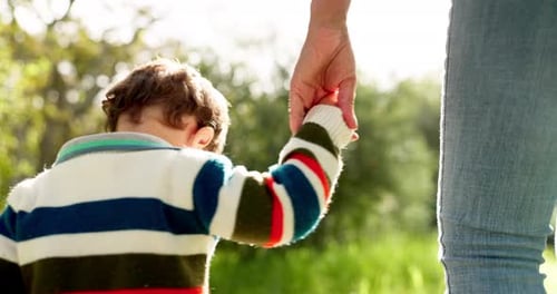 Holding hands, family and walking outdoor at a park with trust, love and care in summer