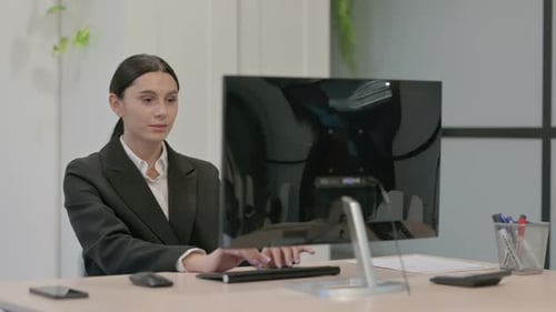 Young Woman Working on Computer in Modern Office