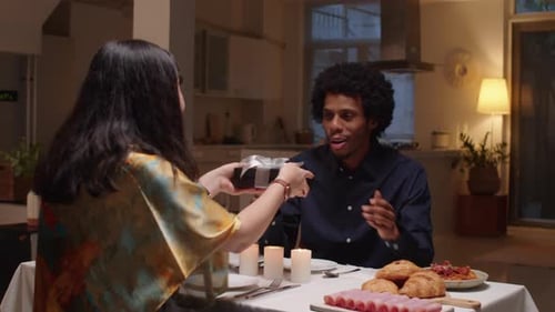 Couple Celebrating With Romantic Dinner and Gift