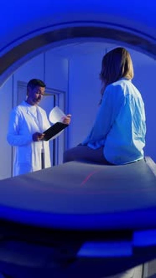 Medical Worker Explaining CT Scan Results to Patient in Hospital Setting MRI Machine and