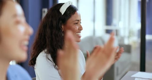 Young Adults Clapping in Modern Workplace