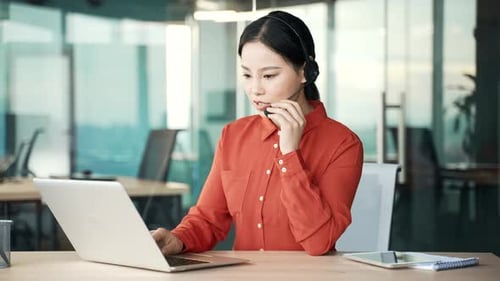 Young Woman Working with Headset and Laptop