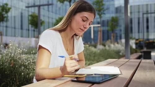 Inspired Blond Woman Studying and Writing Notes at the University Student Girl Thinking and Working