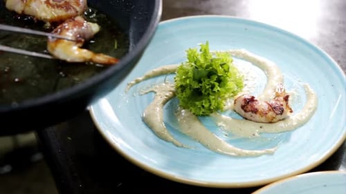 Delicious Roasted Shrimps on Plate with Sauce and Green