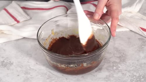 Step By Step Mixing Ingredients in a Glass Mixing Bowl to Prepare Chocolate Mug Cakes