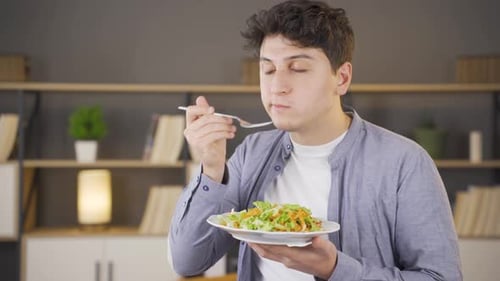 Young Adult Eating Healthy Salad Indoors