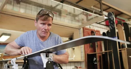 Craftsperson working in snowboard workshop