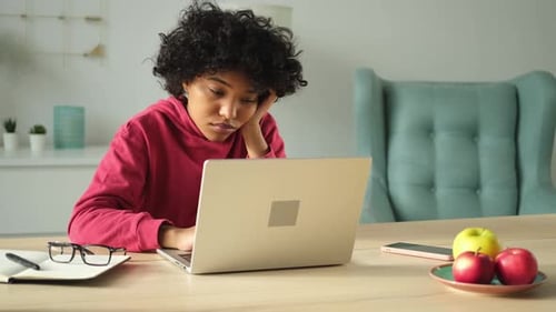 African American Girl Using Laptop at Home Office Looking at Screen Typing Chatting Reading Writing