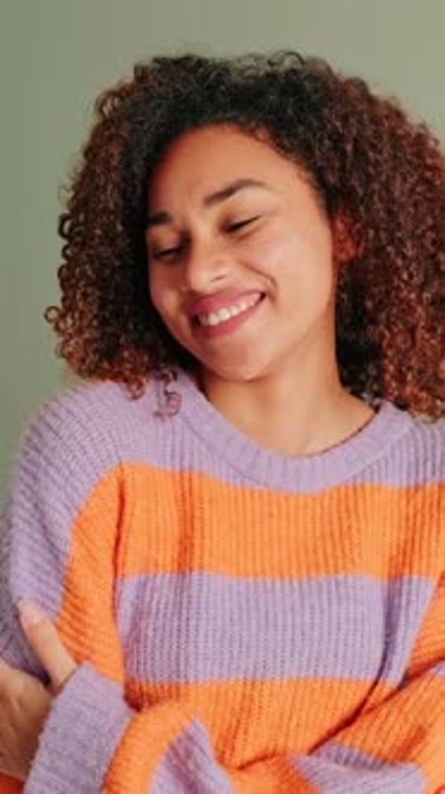 Smiling Woman with Curly Hair Posing Indoors