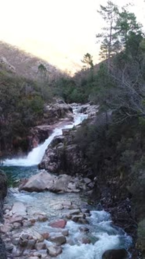 Aerial view of river, mountain, waterfall in Gerês, Portugal Vertical Video