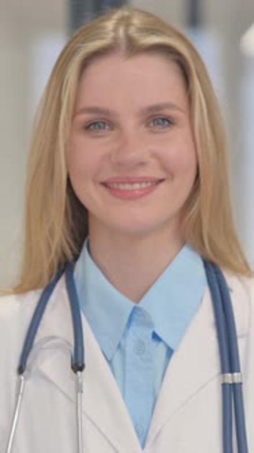 Portrait of Smiling Young Female Doctor, Vertical Video
