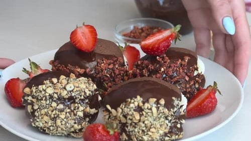 Chocolate Desserts Topped with Nuts and Strawberries