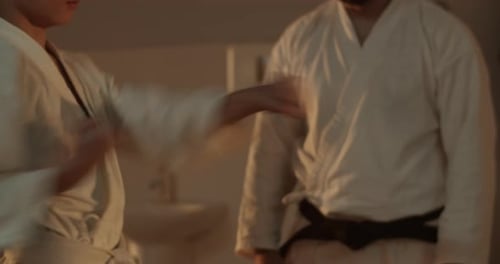 Martial Artists Practice Punching Drills Indoors
