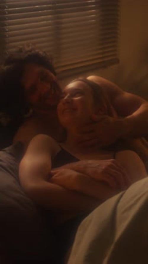 Affectionate Couple Embracing Indoors in Dim Lighting