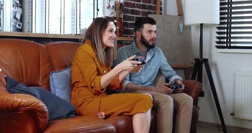 Couple Playing Video Games Together at Home