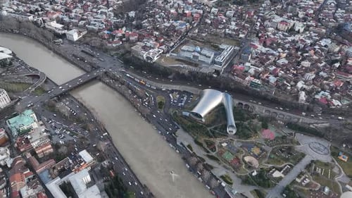 Aerial view of Tbilisi city central park and Bridge of Peace. Beautiful cityscape of old Tbilisi