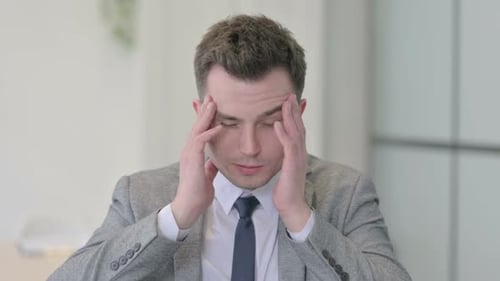 Young Adult with a Headache Rubbing Temples