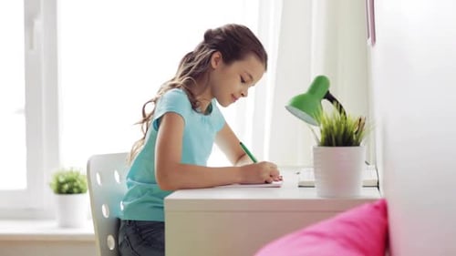 Girl writes at desk in her light filled room