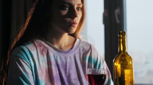 Woman Drinking Wine at Table with Man