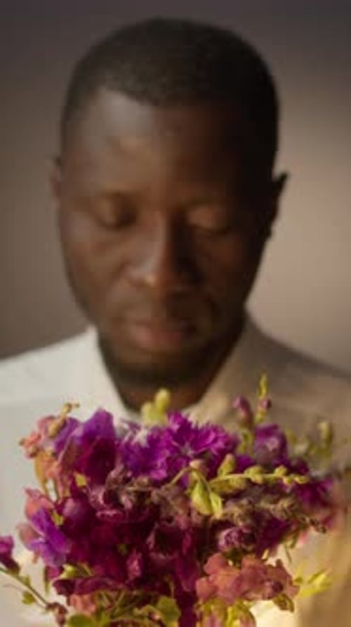 Studio Portrait of Young Black Man with Flowers