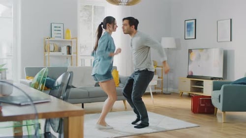 Couple Dances Together in Living Room During Daytime