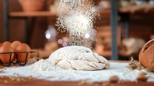In Kitchen of Eco Bakery Pouring Flour on Dough for Bread Closeup View of Organic Food on Table