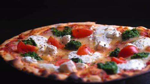 Top view of fresh baked pizza with tomatoes and cheese mozzarella rotate on tray