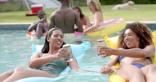 Diverse friends enjoy a pool party