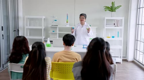 Science Class with Teacher Explaining Experiment to Students