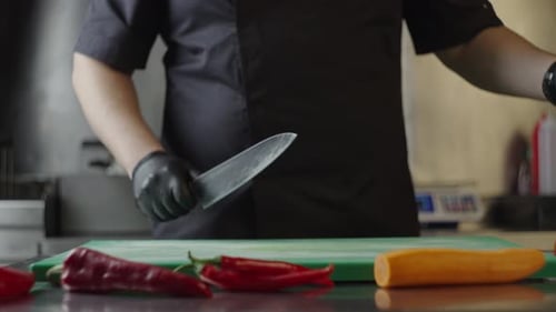 Chef Slicing Celery on Cutting Board