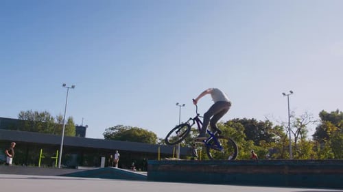 Young Man BMX Bike Jump at Skate Park