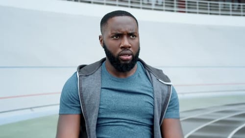 Man Stretching on a Track Field Close Up