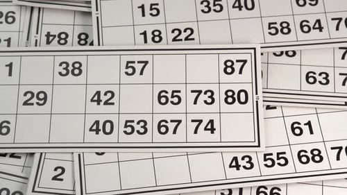 Lotto cards with numbers board game without barrels rotating background top view. Bingo games