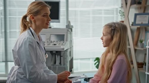 Pediatrician Advising Girl Patient on Health Care Closeup Medical Appointment