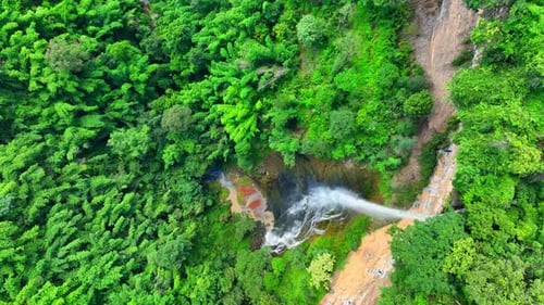 Drone captures stunning cliff waterfall.