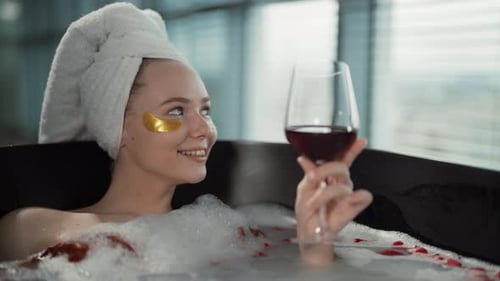 Woman Relax in Milk Bath Drinking Wine Girl Added Eye Patches Resting Lying in Bath with Rose Petals