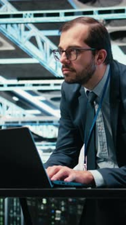 Vertical Video Data Center Admin Typing on Laptop Keyboard Doing Resource Optimization
