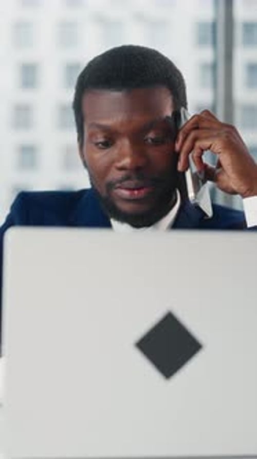 Office Worker Talking By Mobile Phone in Coworking Area Vertical Portrait Handsome African American