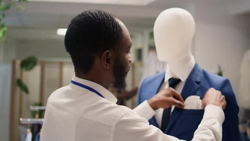 Man Arranges Mannequin in Fashion Shop