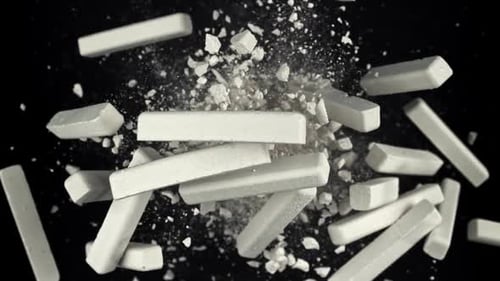School Chalk Flies Up and Falls Down on a Black Background Filmed on a Highspeed Camera at 1000 Fps