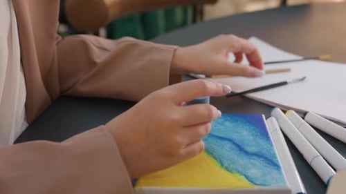 Woman Painting Art Piece at Table Indoors
