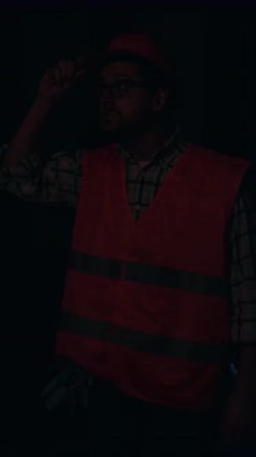 A Construction Worker Dressed in Safety Gear is Present at an Active Job Site Location
