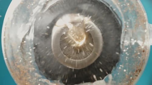 Brewing tea, view from below. Pouring water into the infuser, in slow motion.