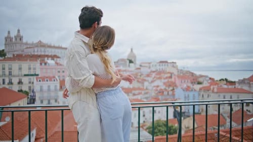 Embracing Lovers Contemplating Seascape at Mediterranean Town Vacation Back View