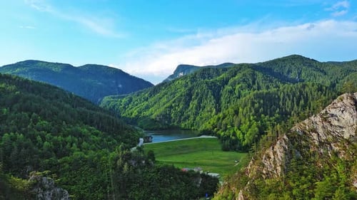 A Winding Road Passes Through Mountain Canyons with Plants with Foliage Under a Day Sky in Rhodope