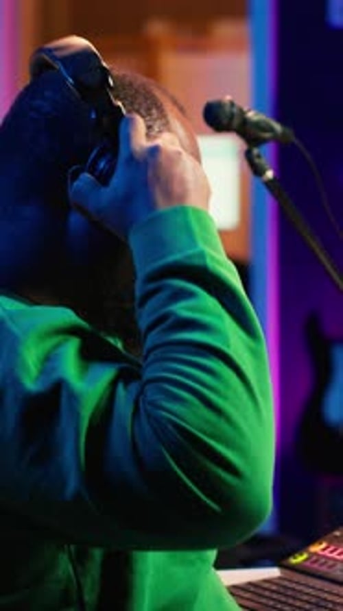 Young Adult Working in Music Studio at Night