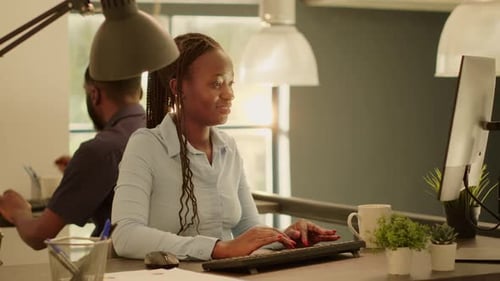 Femme d'affaires naviguant sur Internet sur un ordinateur pour travailler sur un rapport