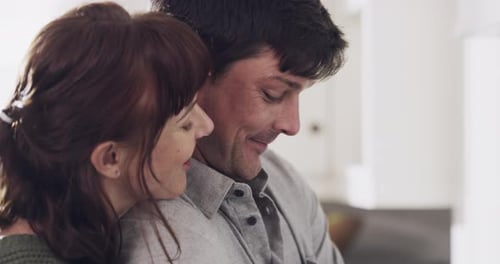 Affectionate Couple Embracing in Home Kitchen